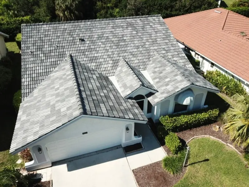Aerial view of a single-story Florida home with a gray concrete tile roof