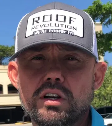 Roof Revolution team member in a Roof Revolution cap