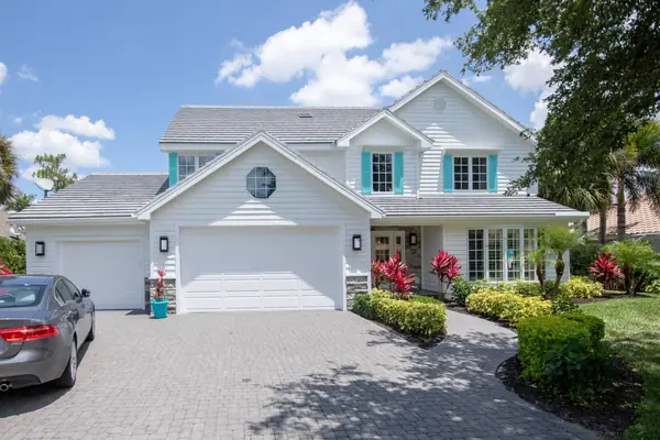 Two-story white home with a gray flat-tile roof and teal shutters